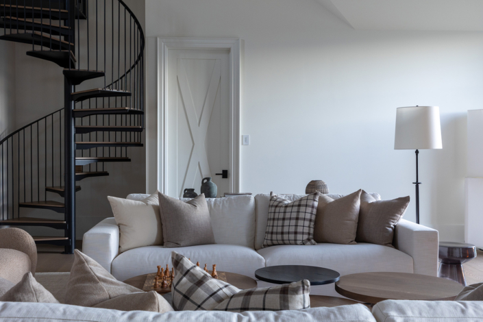 Bright interior design photograph of modern living room with spiral stair case by Harry Gils Photography.